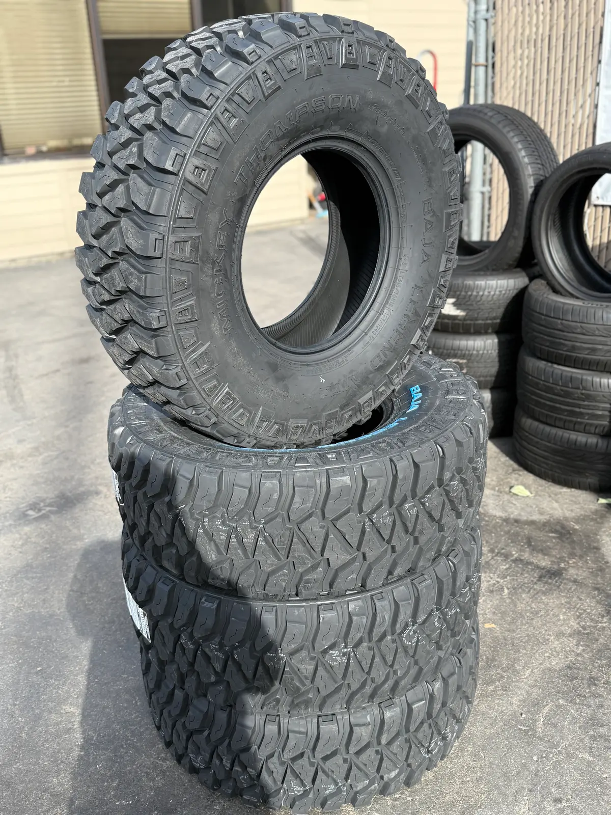 aggressive off-road tire stack displayed at MC Wheels and Tires