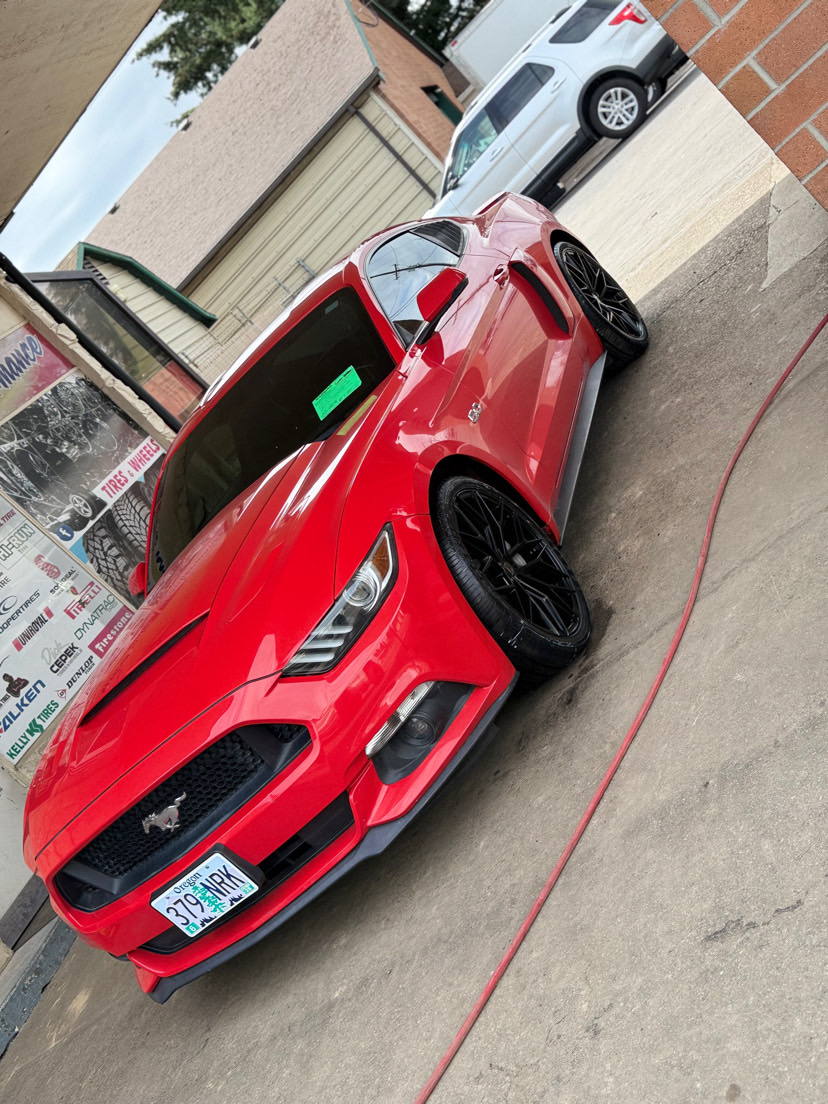 red Ford Mustang with black wheels outside MC Wheels and Tires in Woodburn Oregon