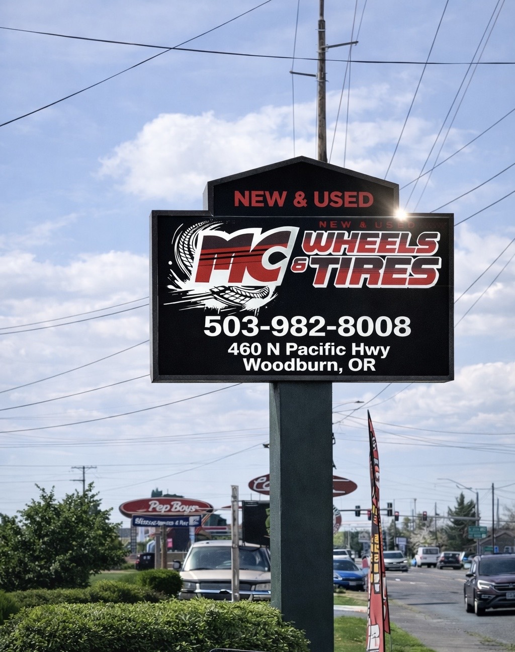 MC Wheels and Tires roadside sign on North Pacific Highway in Woodburn Oregon